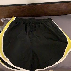 90 Degree by Reflex black, yellow, and white running shorts
